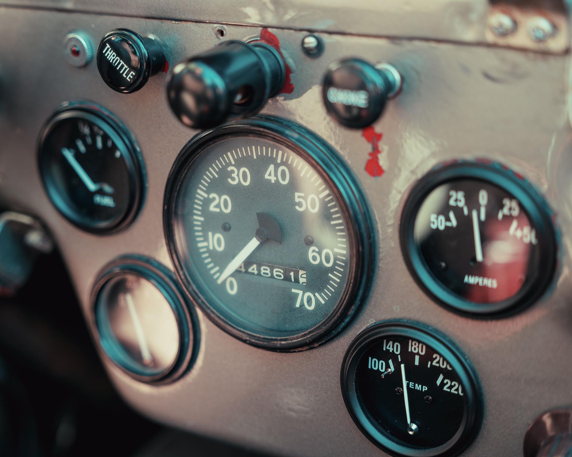 A close-up of a worn instrument panel — gauges an operator can read without the person who installed them standing beside it